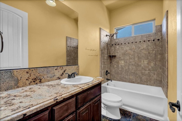 full bathroom with vanity, toilet, and tiled shower / bath