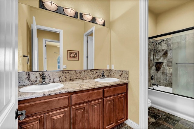 full bathroom featuring toilet, vanity, and bath / shower combo with glass door