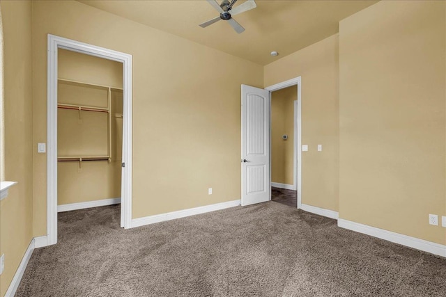 unfurnished bedroom with a walk in closet, carpet floors, ceiling fan, and a closet