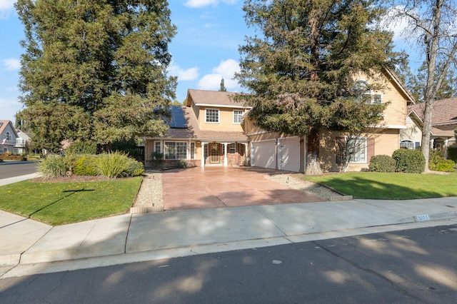 view of front facade with a garage and a front lawn