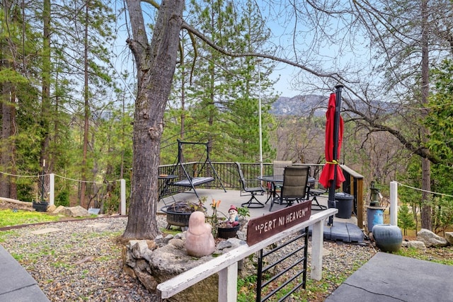 view of yard with an outdoor fire pit and a mountain view