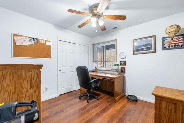 office with dark wood-type flooring and ceiling fan