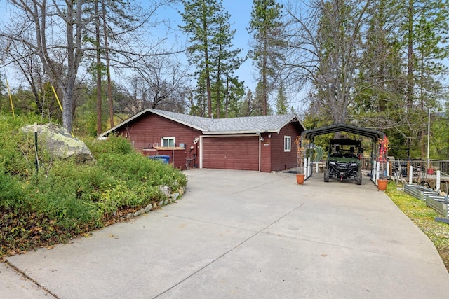 view of side of property with a carport and a garage