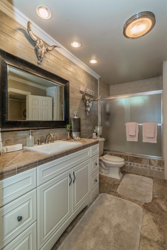 bathroom featuring ornamental molding, vanity, toilet, and a shower