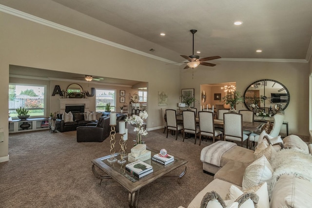 carpeted living room with vaulted ceiling, crown molding, and ceiling fan