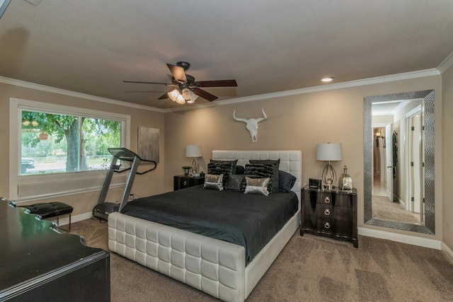 carpeted bedroom with crown molding and ceiling fan