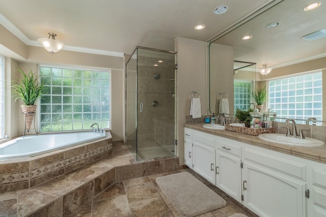 bathroom with vanity, ornamental molding, and independent shower and bath