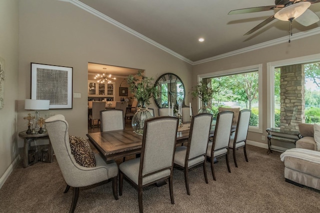 dining room featuring vaulted ceiling, carpet floors, ceiling fan with notable chandelier, and crown molding