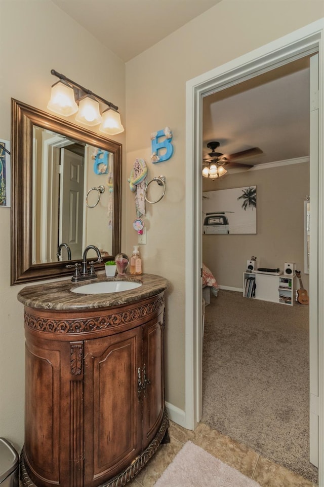 bathroom featuring ceiling fan, vanity, and ornamental molding