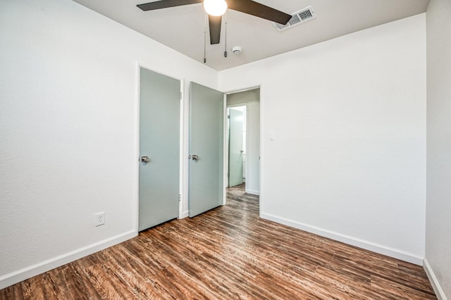 empty room with hardwood / wood-style flooring and ceiling fan