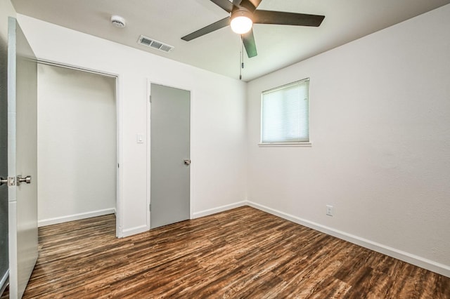 unfurnished bedroom featuring dark hardwood / wood-style floors, a closet, and ceiling fan