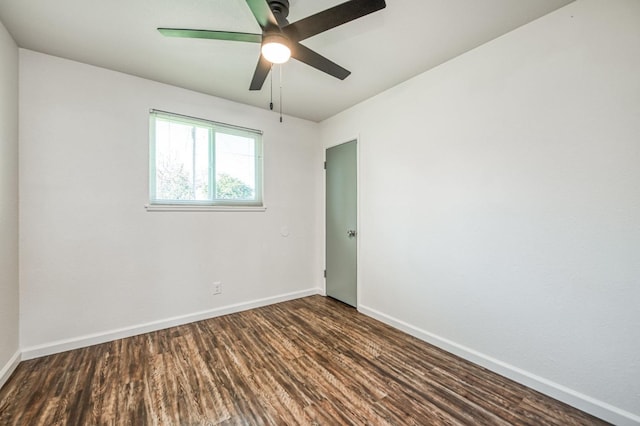 spare room featuring ceiling fan and dark hardwood / wood-style flooring