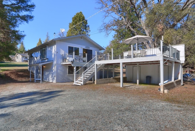 back of house with a deck