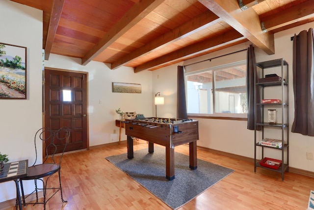 game room featuring wooden ceiling, light hardwood / wood-style floors, and beamed ceiling