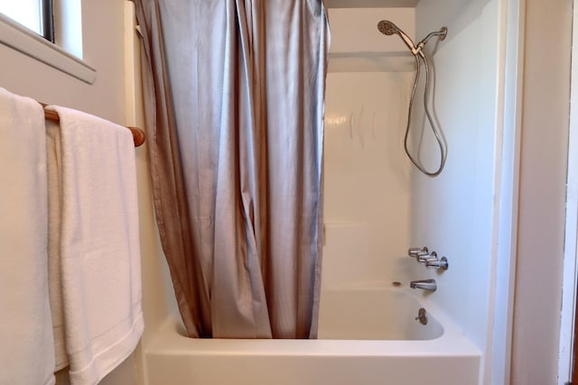 bathroom featuring shower / bathtub combination with curtain