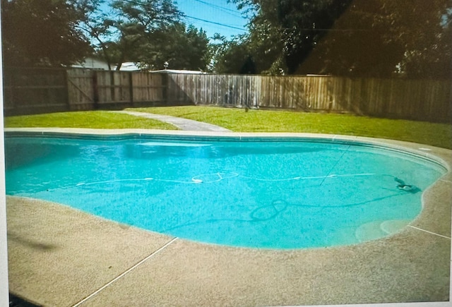 view of pool featuring a yard