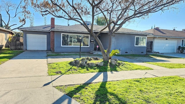 ranch-style house with a garage and a front lawn