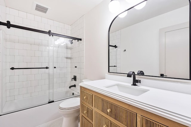 full bathroom featuring bath / shower combo with glass door, vanity, and toilet