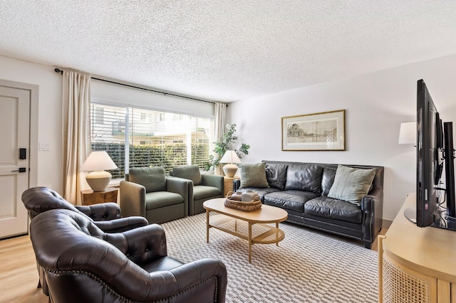 living room featuring a textured ceiling and light hardwood / wood-style floors