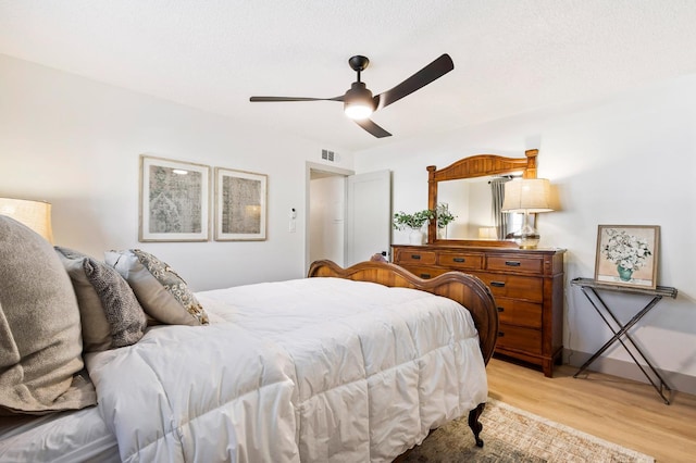 bedroom with ceiling fan and light hardwood / wood-style flooring