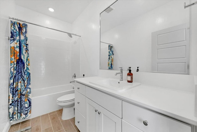 full bathroom featuring vanity, toilet, and shower / tub combo