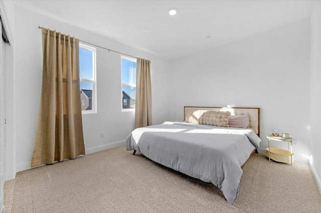 bedroom featuring light carpet