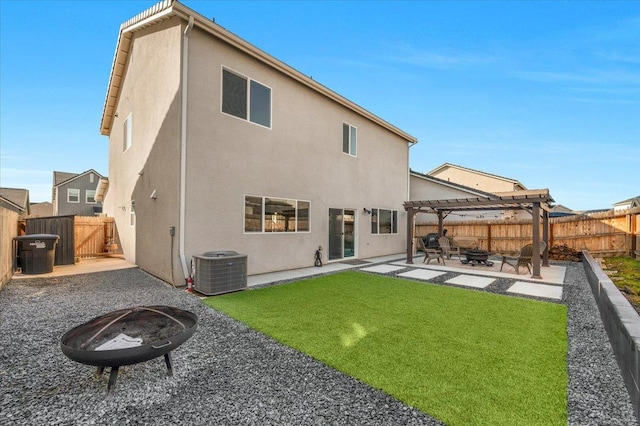 back of house with cooling unit, a yard, a pergola, a patio, and an outdoor fire pit