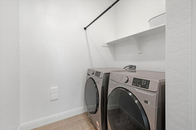 washroom with washing machine and clothes dryer