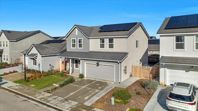 view of front of home featuring a garage and solar panels