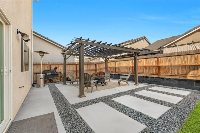 view of patio / terrace with a pergola and a fire pit