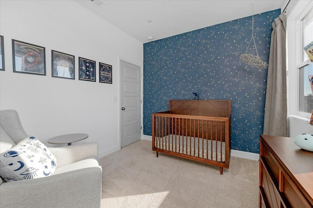 carpeted bedroom featuring a crib