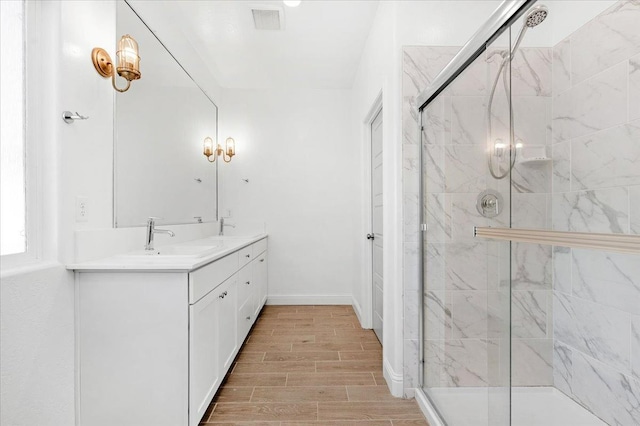 bathroom with an enclosed shower and vanity