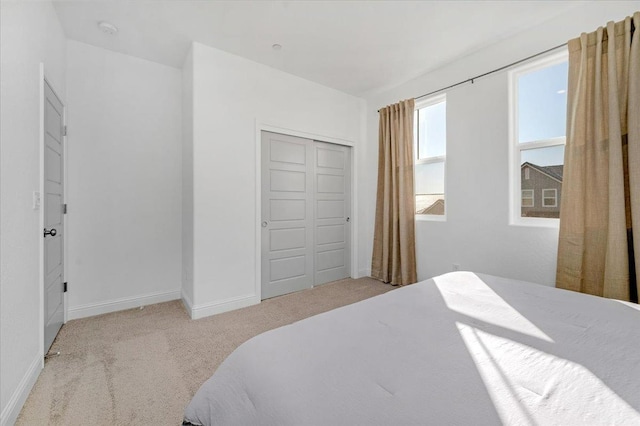 carpeted bedroom with a closet