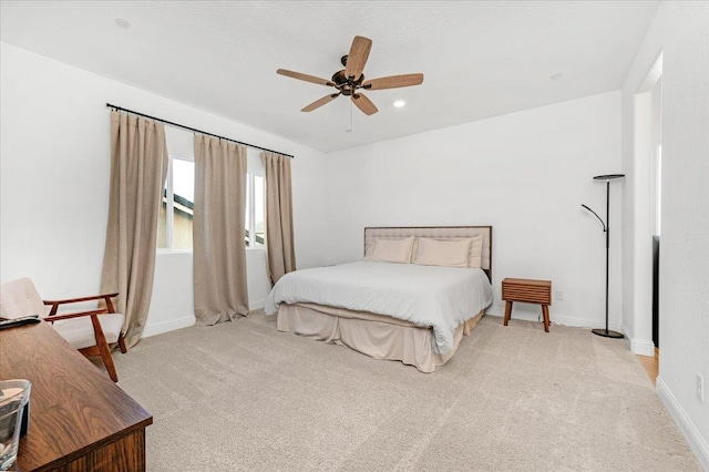 bedroom with light colored carpet and ceiling fan