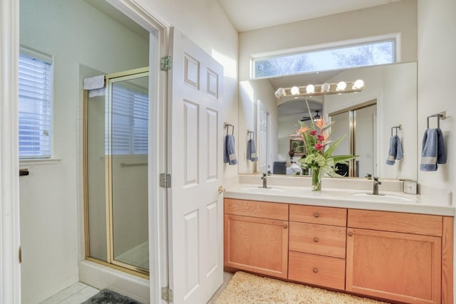 bathroom featuring vanity and a shower with door