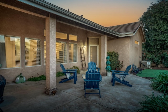 patio terrace at dusk featuring central air condition unit