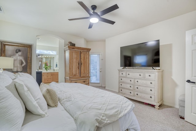 carpeted bedroom featuring ensuite bathroom and ceiling fan