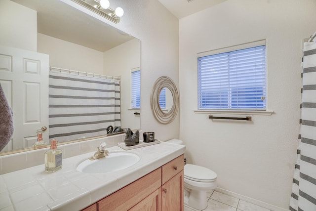 bathroom featuring vanity, tile patterned floors, and toilet