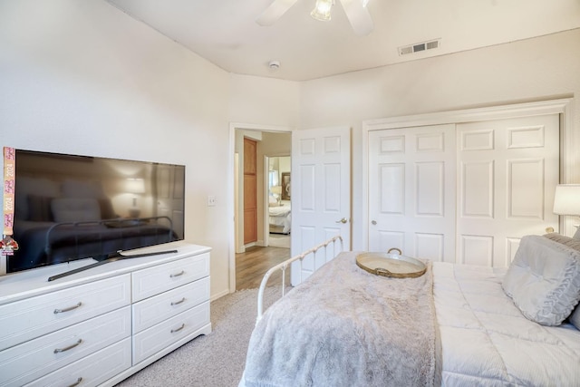 carpeted bedroom featuring ceiling fan and a closet