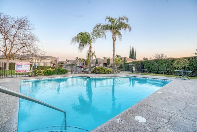 view of pool at dusk