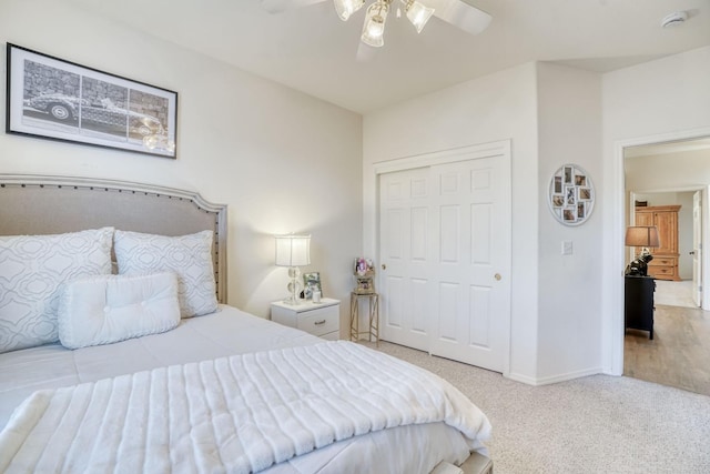 carpeted bedroom featuring ceiling fan and a closet