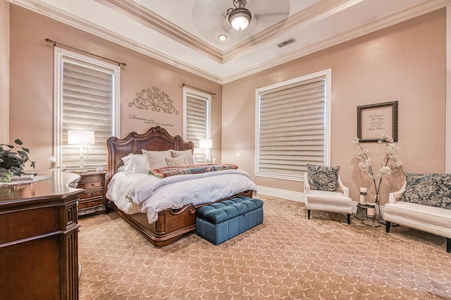 bedroom featuring a raised ceiling, crown molding, and ceiling fan