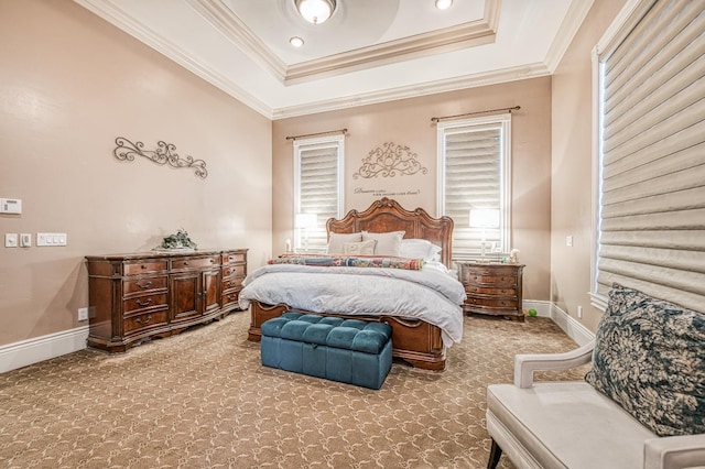 carpeted bedroom featuring crown molding and a tray ceiling