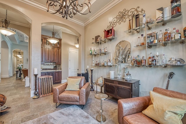 sitting room featuring ornamental molding and a chandelier