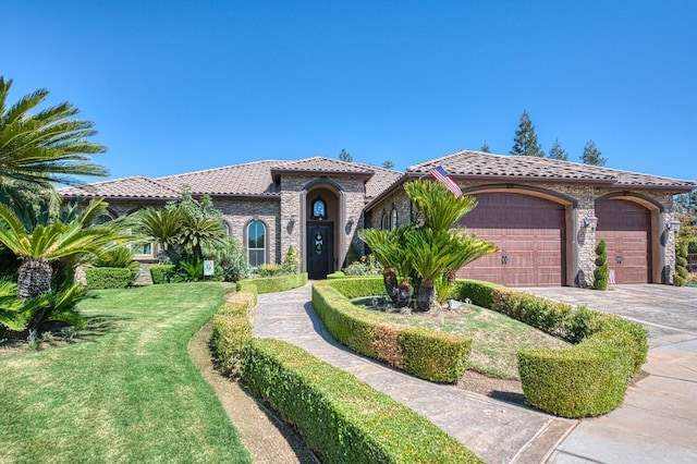 mediterranean / spanish-style home with a garage and a front yard