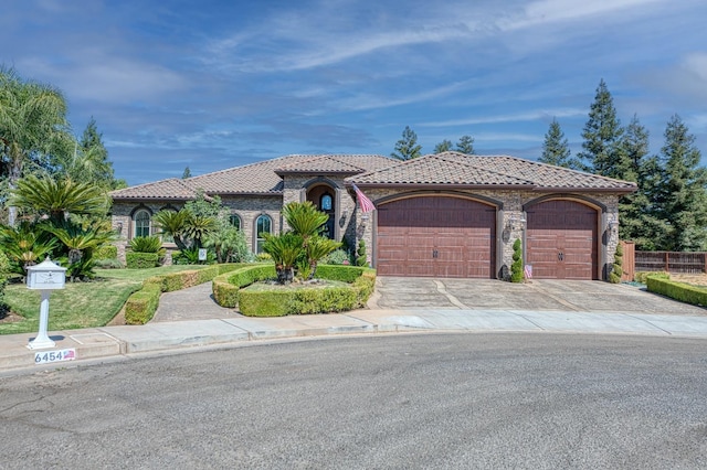 mediterranean / spanish home featuring a garage