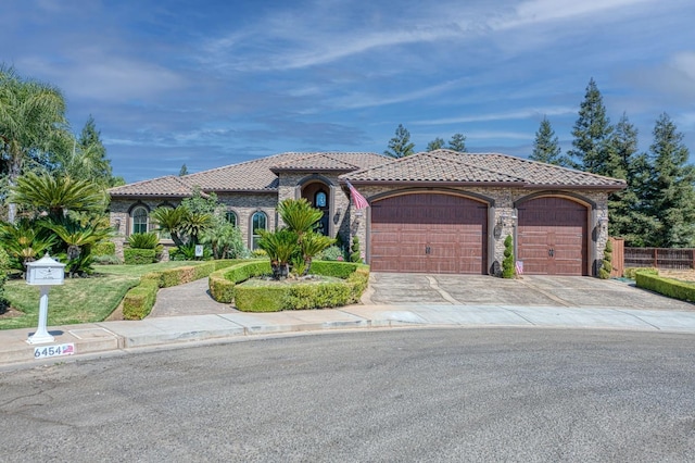 mediterranean / spanish house with a garage