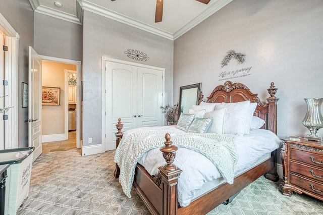 bedroom with crown molding, ceiling fan, a closet, and a towering ceiling