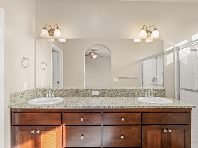 bathroom featuring vanity, an enclosed shower, and ceiling fan