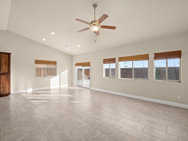 tiled empty room with vaulted ceiling and ceiling fan